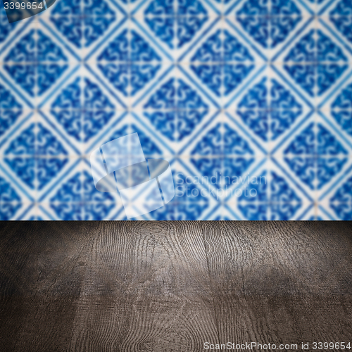 Image of Wood table top and blur vintage ceramic tile pattern wall