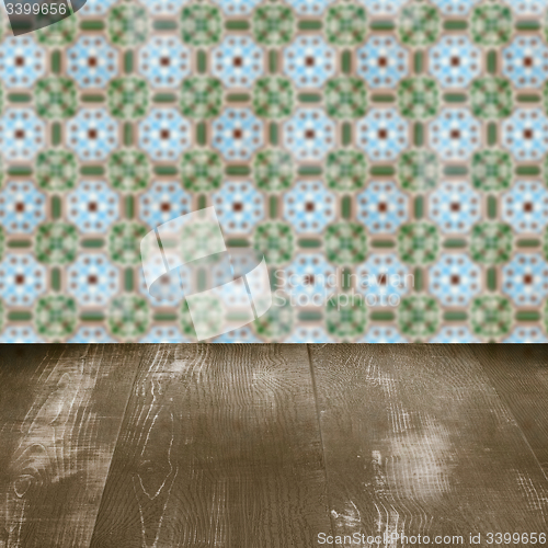 Image of Wood table top and blur vintage ceramic tile pattern wall