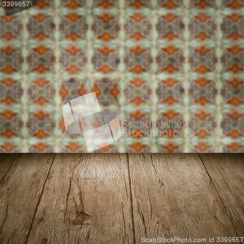 Image of Wood table top and blur vintage ceramic tile pattern wall