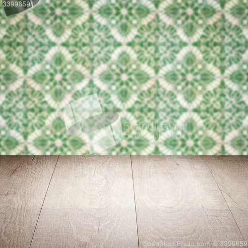 Image of Wood table top and blur vintage ceramic tile pattern wall