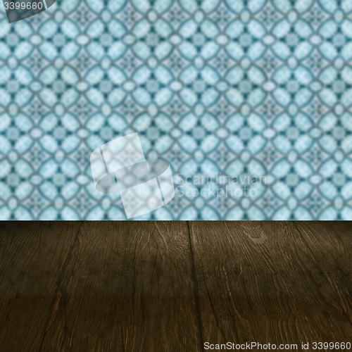 Image of Wood table top and blur vintage ceramic tile pattern wall