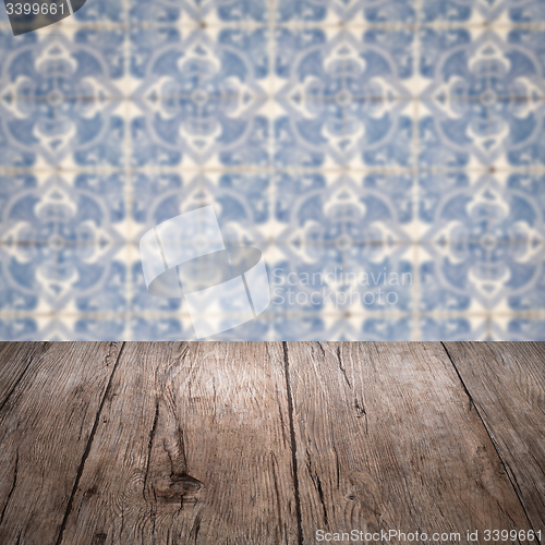 Image of Wood table top and blur vintage ceramic tile pattern wall