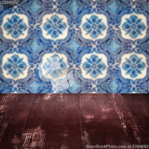 Image of Wood table top and blur vintage ceramic tile pattern wall