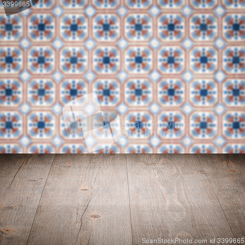 Image of Wood table top and blur vintage ceramic tile pattern wall