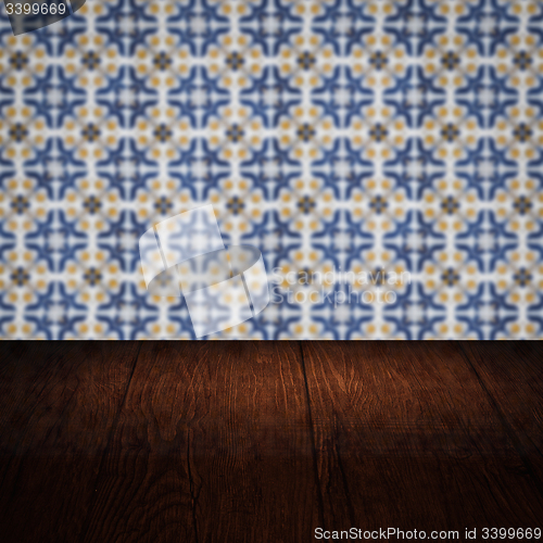 Image of Wood table top and blur vintage ceramic tile pattern wall