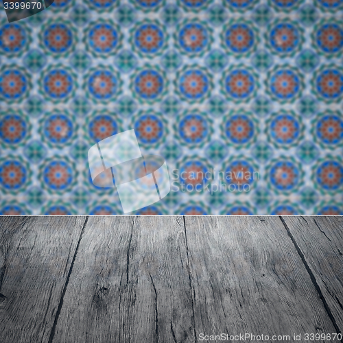 Image of Wood table top and blur vintage ceramic tile pattern wall