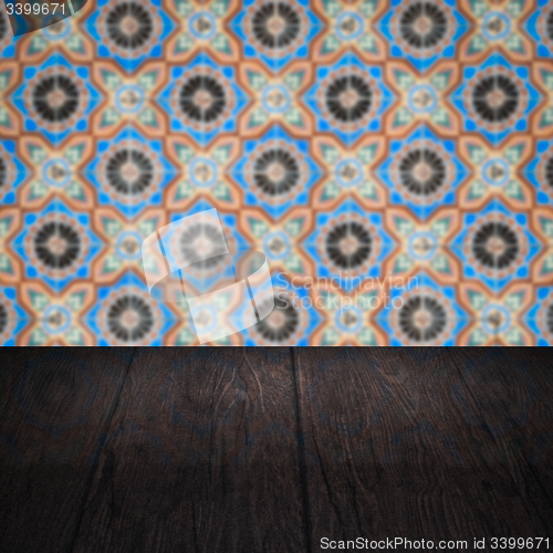 Image of Wood table top and blur vintage ceramic tile pattern wall