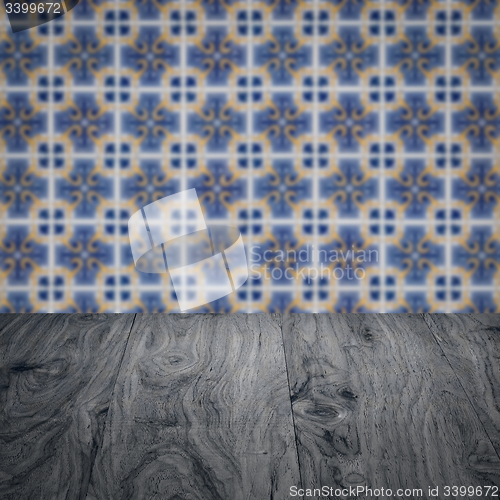 Image of Wood table top and blur vintage ceramic tile pattern wall