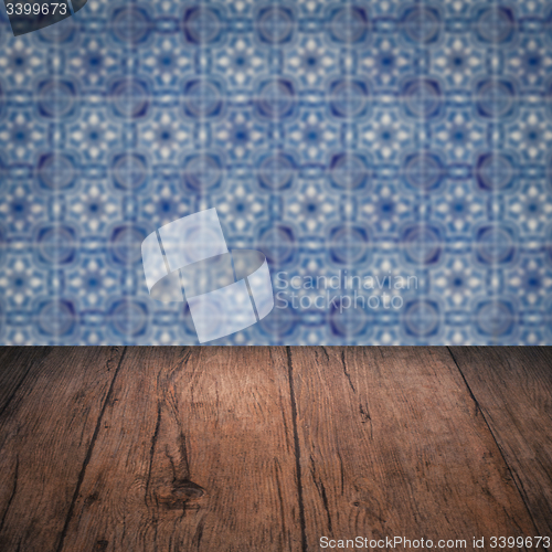 Image of Wood table top and blur vintage ceramic tile pattern wall