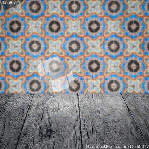 Image of Wood table top and blur vintage ceramic tile pattern wall