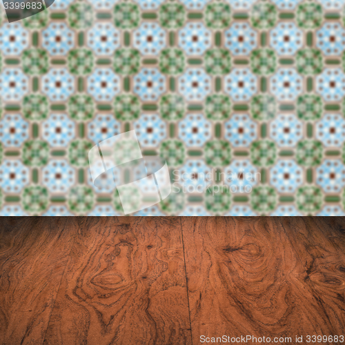 Image of Wood table top and blur vintage ceramic tile pattern wall