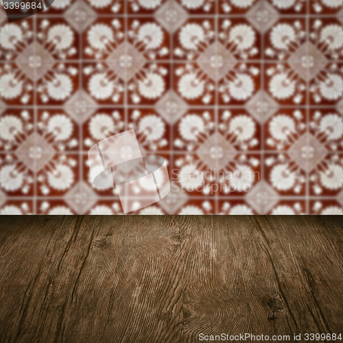 Image of Wood table top and blur vintage ceramic tile pattern wall