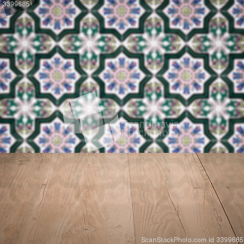 Image of Wood table top and blur vintage ceramic tile pattern wall