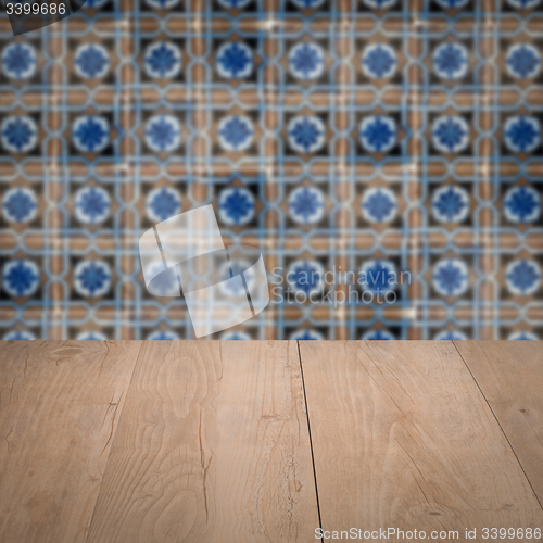 Image of Wood table top and blur vintage ceramic tile pattern wall