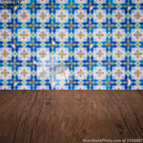 Image of Wood table top and blur vintage ceramic tile pattern wall