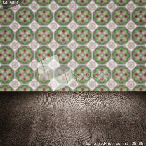 Image of Wood table top and blur vintage ceramic tile pattern wall