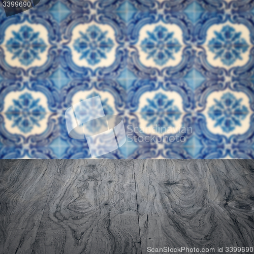 Image of Wood table top and blur vintage ceramic tile pattern wall