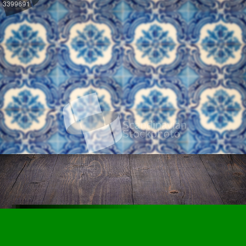 Image of Wood table top and blur vintage ceramic tile pattern wall