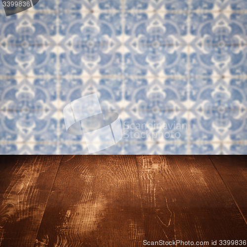Image of Wood table top and blur vintage ceramic tile pattern wall