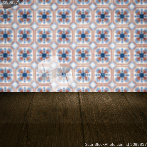 Image of Wood table top and blur vintage ceramic tile pattern wall