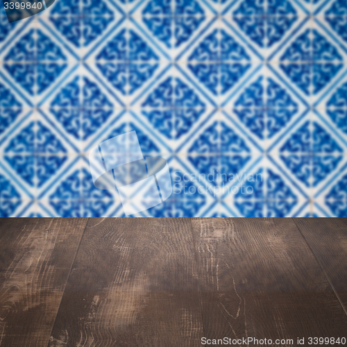 Image of Wood table top and blur vintage ceramic tile pattern wall