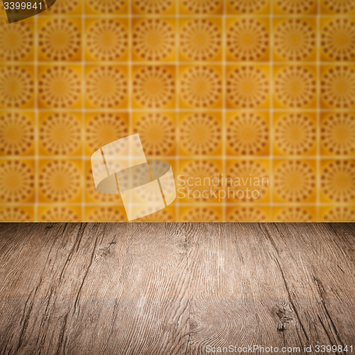 Image of Wood table top and blur vintage ceramic tile pattern wall