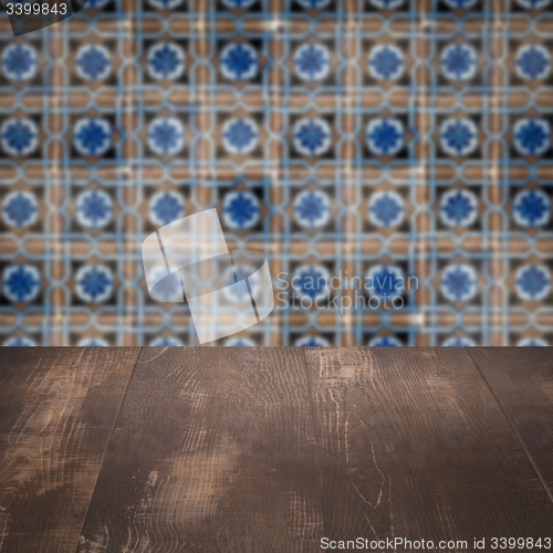 Image of Wood table top and blur vintage ceramic tile pattern wall