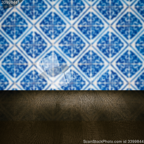 Image of Wood table top and blur vintage ceramic tile pattern wall