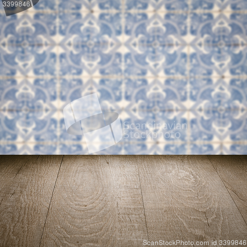 Image of Wood table top and blur vintage ceramic tile pattern wall