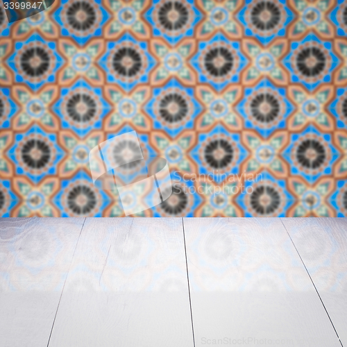 Image of Wood table top and blur vintage ceramic tile pattern wall