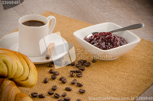 Image of Cup of black coffee and croissant 