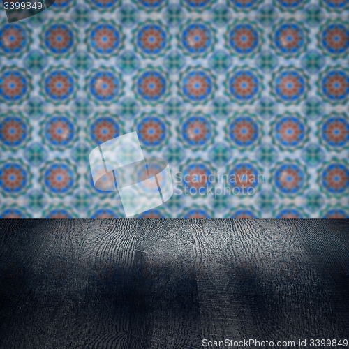 Image of Wood table top and blur vintage ceramic tile pattern wall