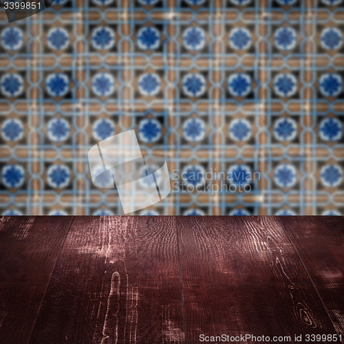 Image of Wood table top and blur vintage ceramic tile pattern wall