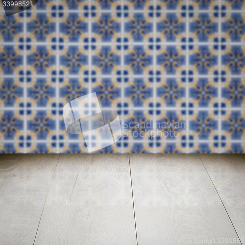 Image of Wood table top and blur vintage ceramic tile pattern wall