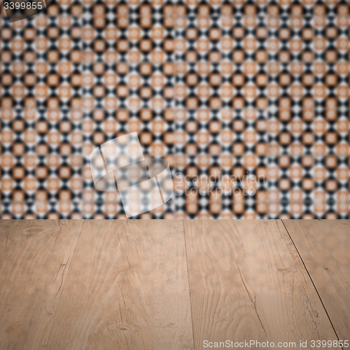 Image of Wood table top and blur vintage ceramic tile pattern wall