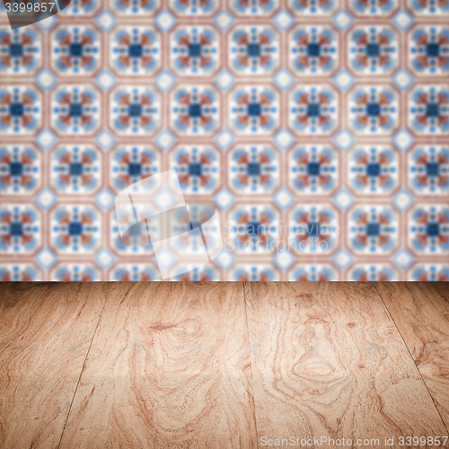 Image of Wood table top and blur vintage ceramic tile pattern wall