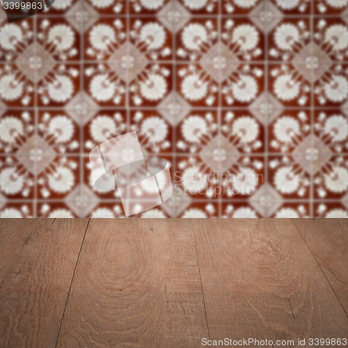 Image of Wood table top and blur vintage ceramic tile pattern wall
