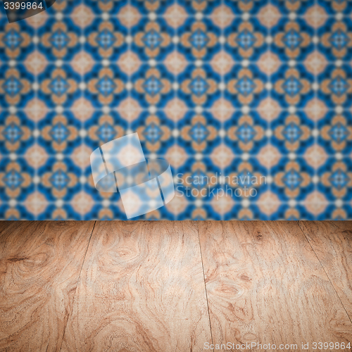 Image of Wood table top and blur vintage ceramic tile pattern wall