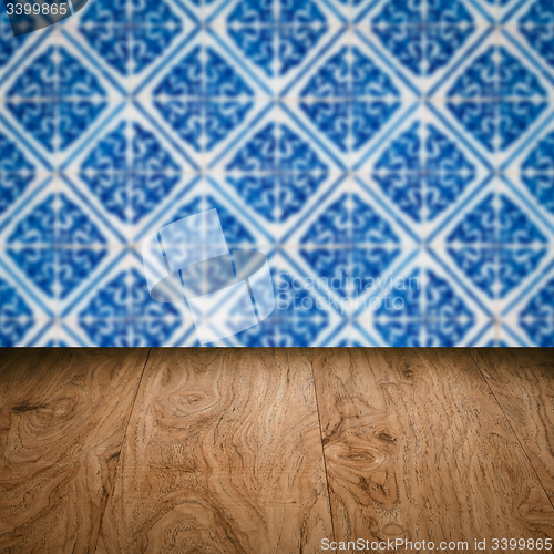 Image of Wood table top and blur vintage ceramic tile pattern wall