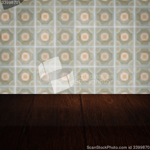 Image of Wood table top and blur vintage ceramic tile pattern wall