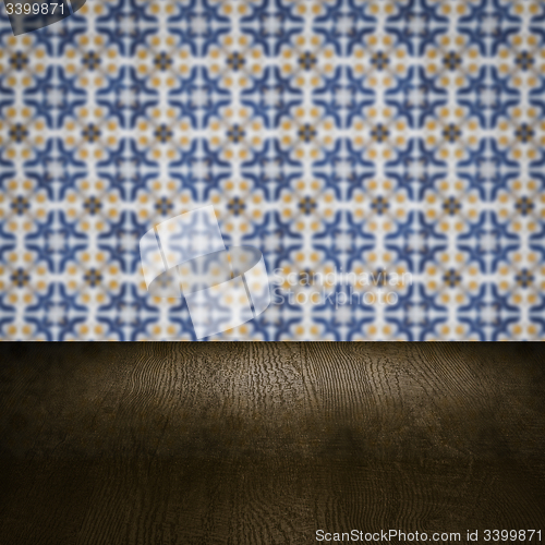 Image of Wood table top and blur vintage ceramic tile pattern wall