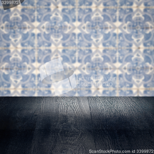 Image of Wood table top and blur vintage ceramic tile pattern wall