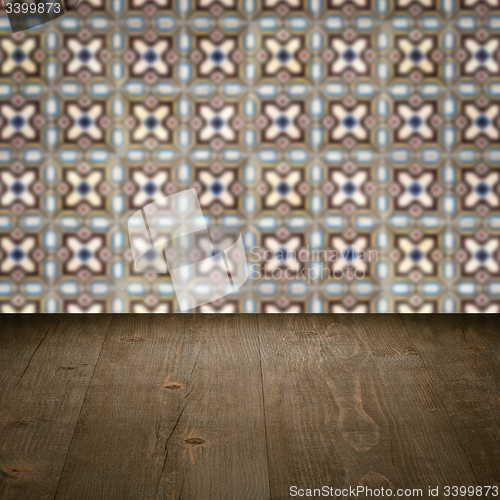 Image of Wood table top and blur vintage ceramic tile pattern wall