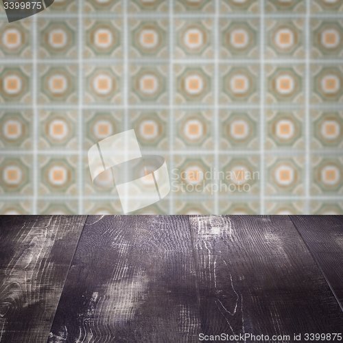 Image of Wood table top and blur vintage ceramic tile pattern wall