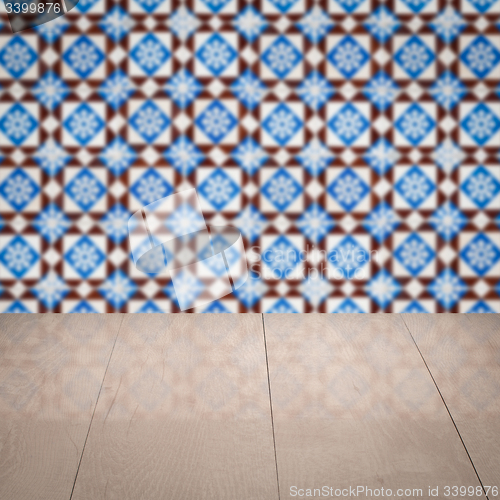 Image of Wood table top and blur vintage ceramic tile pattern wall