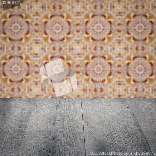 Image of Wood table top and blur vintage ceramic tile pattern wall