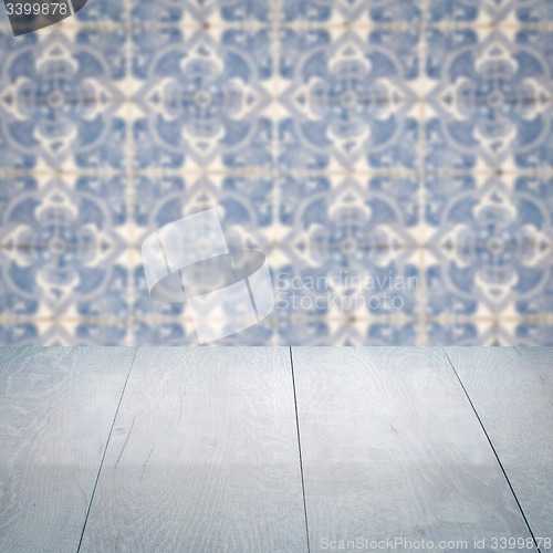 Image of Wood table top and blur vintage ceramic tile pattern wall