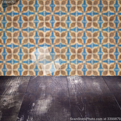 Image of Wood table top and blur vintage ceramic tile pattern wall