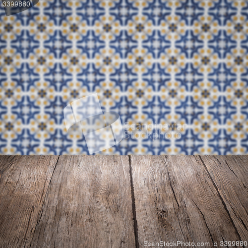 Image of Wood table top and blur vintage ceramic tile pattern wall