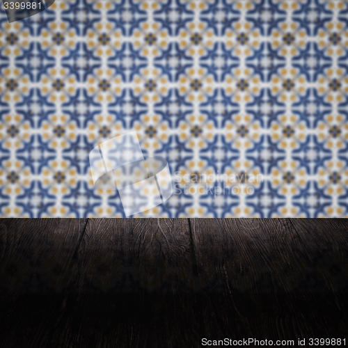 Image of Wood table top and blur vintage ceramic tile pattern wall